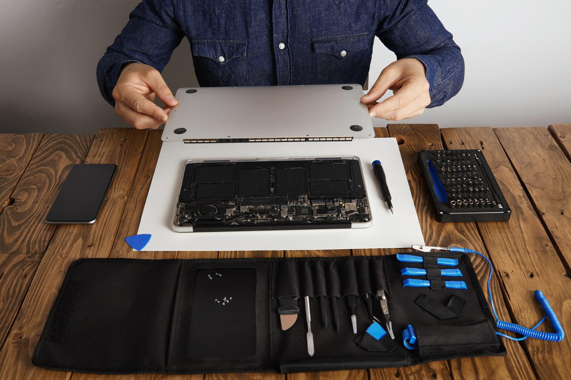 A technician performing a macbook repairs at Horizon Phone Shop.